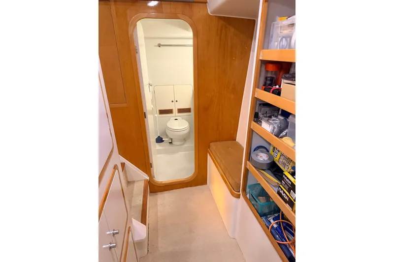 Slide: The Image of Interior of 2002 Norris Custom Motor Catamaran 41.4, featuring bathroom and storage shelves. - 80
