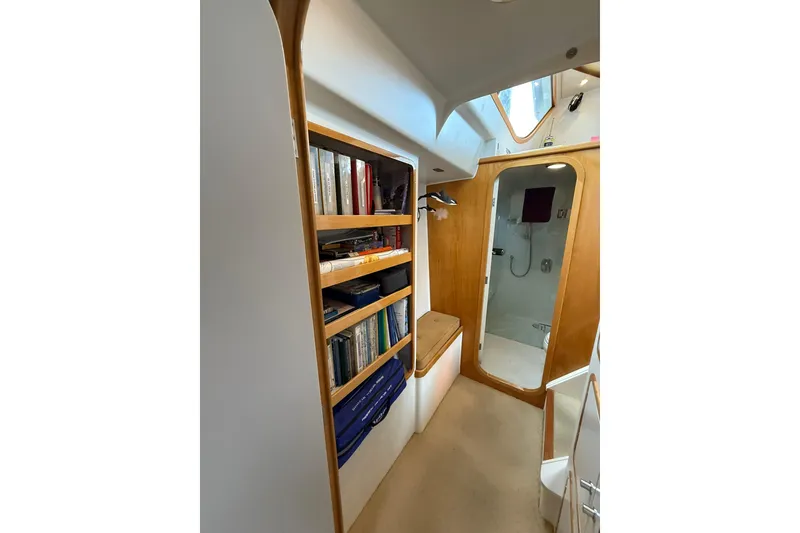 Slide: The Image of Interior of 2002 Norris Custom Motor Catamaran 41.4 with bookshelf and shower area. - 82