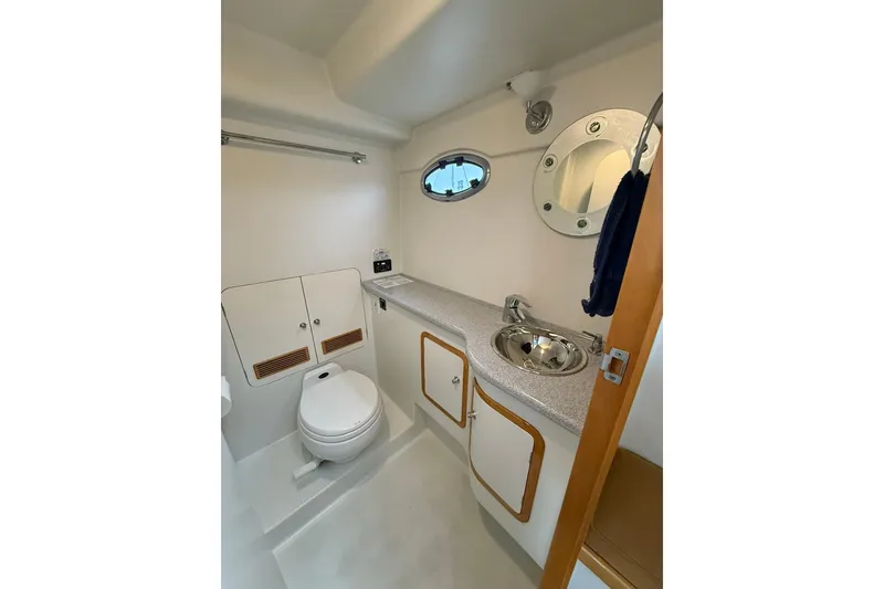 Slide: The Image of Bathroom interior of 2002 Norris Custom Motor Catamaran 41.4, featuring sink and toilet. - 83