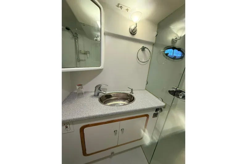 Slide: The Image of Bathroom interior of 2002 Norris Custom Motor Catamaran 41.4 with sink and mirror. - 89