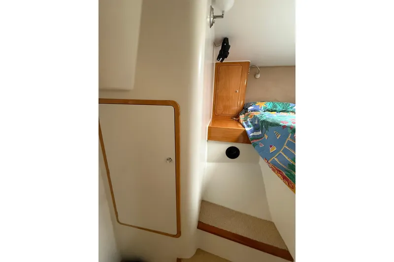 Slide: The Image of Interior cabin of 2002 Norris Custom Motor Catamaran 41.4 with colorful bedding and wooden cabinetry. - 94