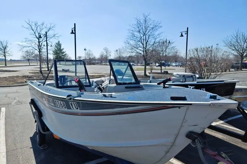 The Image of 1987 Blue Fin S170 boat on trailer in parking lot, clear day. - 1