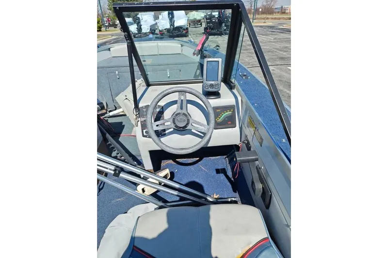 Slide: The Image of Interior of a 1987 Blue Fin S170 boat showing steering wheel and dashboard controls. - 4