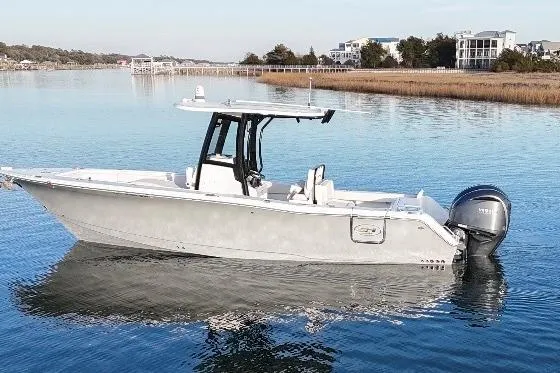 The Image of 2022 Sea Hunt Gamefish 27 Coffin Box boat on calm water, scenic background. - 1