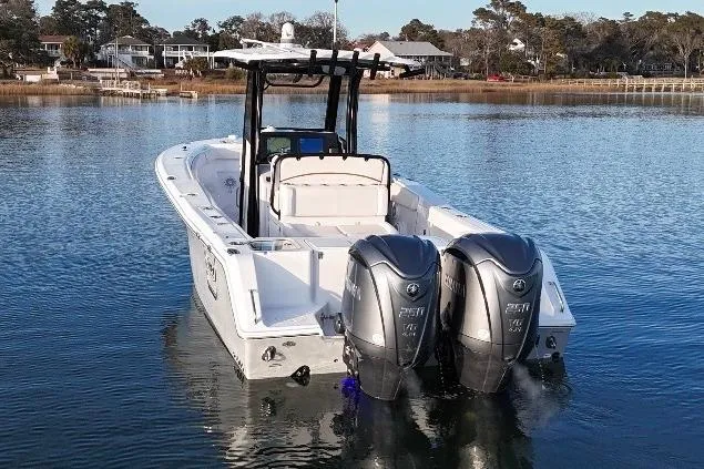 Slide: The Image of 2022 Sea Hunt Gamefish 27 Coffin Box boat with dual engines on a calm lake. - 4