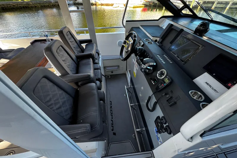 Slide: The Image of 2017 Axopar 37 Sun Top boat interior with modern helm and seating. - 15
