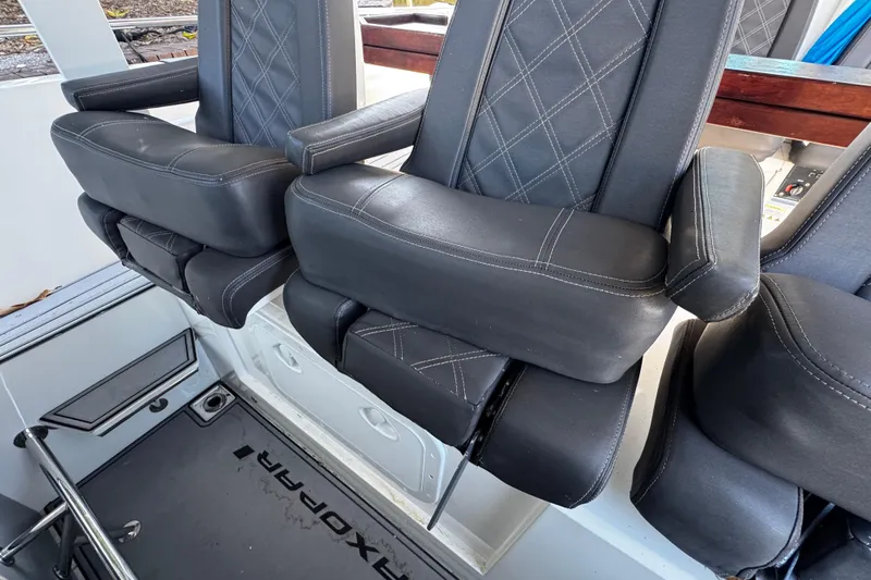 Slide: The Image of 2017 Axopar 37 Sun Top boat seats with black leather and diamond stitching. - 17