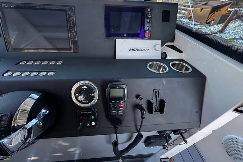 Slide: The Image of Control panel of 2017 Axopar 37 Sun Top boat with navigation and communication equipment. - 23