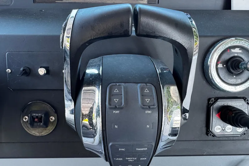 Slide: The Image of Control panel of a 2017 Axopar 37 Sun Top boat with throttle and switches. - 25