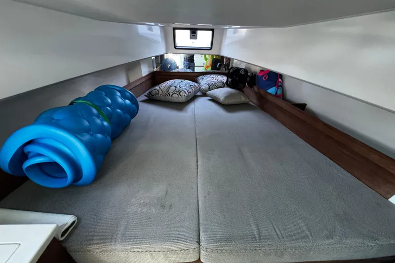 Slide: The Image of Cozy cabin interior of 2017 Axopar 37 Sun Top with cushions and rolled blue mat. - 31