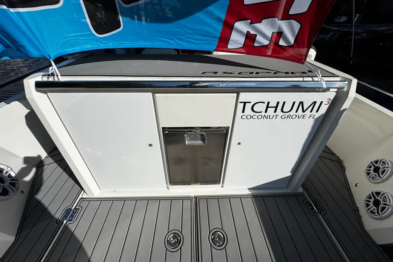 Slide: The Image of 2017 Axopar 37 Sun Top boat deck with "TCHUMI³" branding, Coconut Grove, FL. - 9