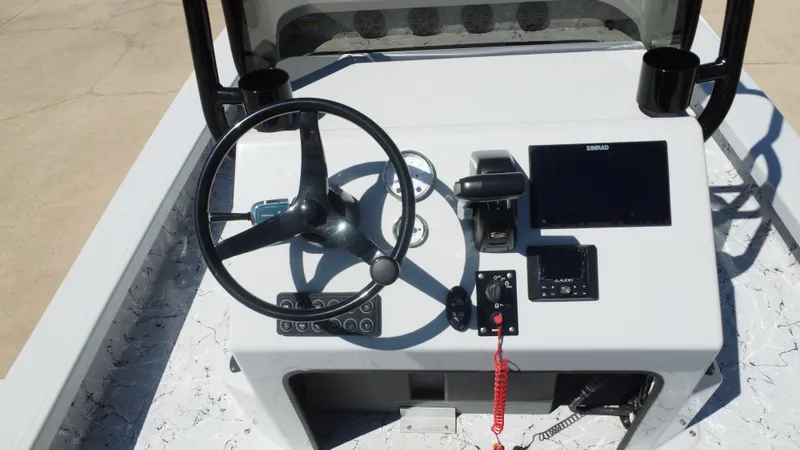 Slide: The Image of 2024 Majek 21RFL boat console with steering wheel and Simrad display. - 25