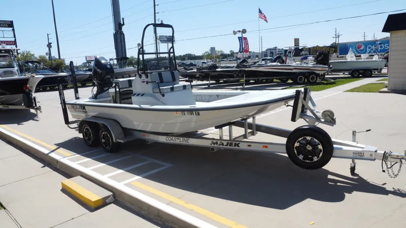 Slide: The Image of 2024 Majek 21RFL boat displayed outdoors on a trailer. - 8