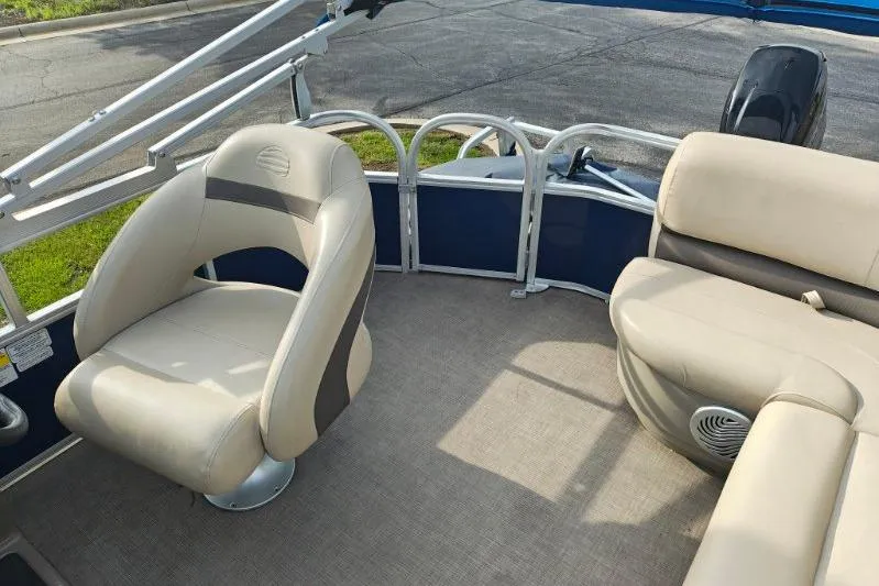 Slide: The Image of 2020 Sun Tracker Party Barge 18 interior with beige seating and carpeted floor. - 11