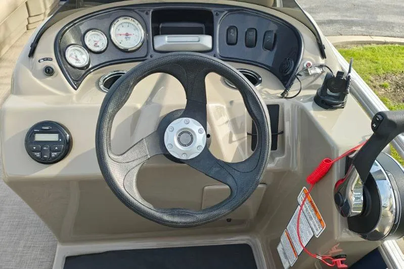 Slide: The Image of 2020 Sun Tracker Party Barge 18 dashboard with steering wheel and controls. - 15