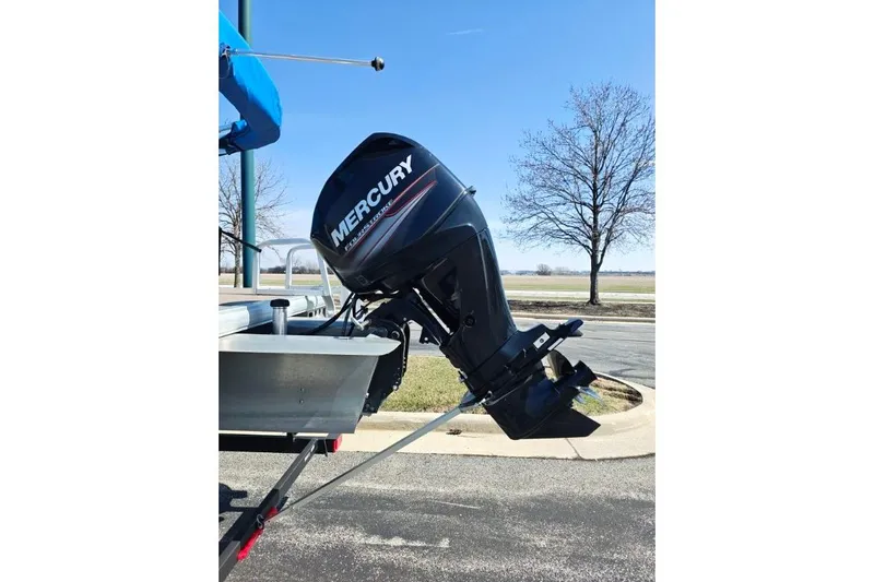 Slide: The Image of 2020 SUNTRACKER pb18 with Mercury outboard motor on a trailer. - 20