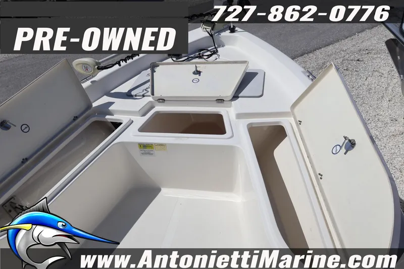 Slide: The Image of Pre-owned 2018 NauticStar 2140 Sport boat with open storage compartments, contact Antonietti Marine. - 12