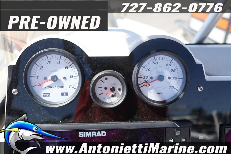 Slide: The Image of Dashboard of a pre-owned 2018 NauticStar 2140 Sport boat with gauges and contact details. - 19