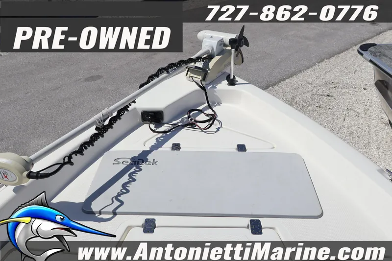 Slide: The Image of Pre-owned 2018 NauticStar 2140 Sport boat deck with trolling motor, contact info displayed. - 8