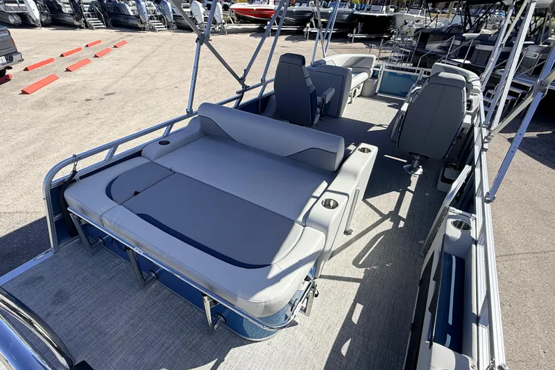 Slide: The Image of 2026 Avalon 2585 Venture 85 VRB Tri Toon boat interior with gray seating and cup holders. - 10