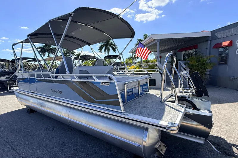 Slide: The Image of 2026 Avalon 2585 Venture 85 VRB Tri Toon boat with canopy, parked outdoors. - 9