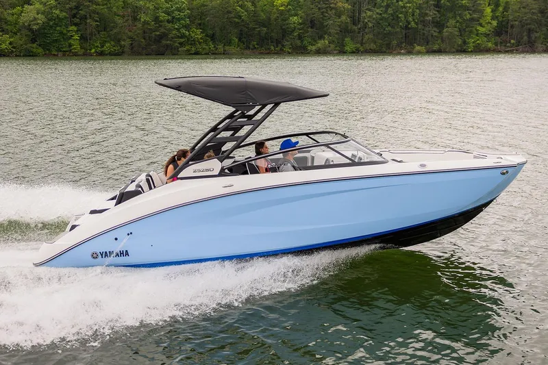 Slide: The Image of Manufacturer Provided Image: 2026 Yamaha Boats 252SE cruising on a lake with passengers, surrounded by lush greenery. - 1