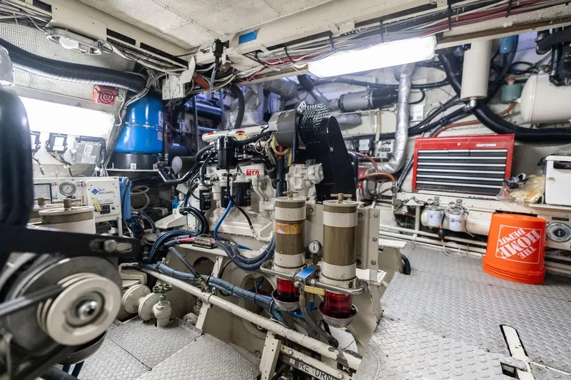 Slide: The Image of Engine room of a 1965 De Vries Lentsch 64 Motoryacht, showcasing mechanical components and tools. - 107