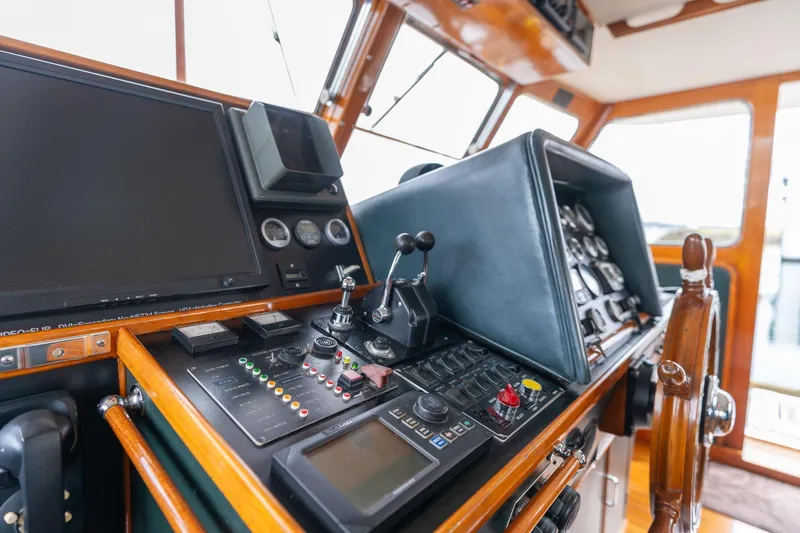 Slide: The Image of Cockpit of 1965 De Vries Lentsch 64 Motoryacht with navigation controls and wooden steering wheel. - 11
