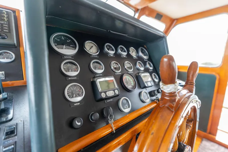 Slide: The Image of Control panel of a 1965 De Vries Lentsch 64 Motoryacht with wooden steering wheel. - 113