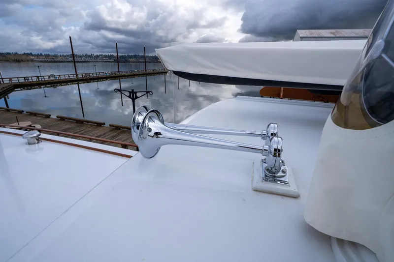 Slide: The Image of Chrome horn on 1965 De Vries Lentsch 64 Motoryacht, docked under cloudy skies. - 117
