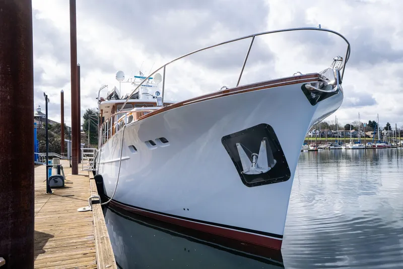 Slide: The Image of Classic 1965 De Vries Lentsch 64 Motoryacht docked at marina under cloudy sky. - 121