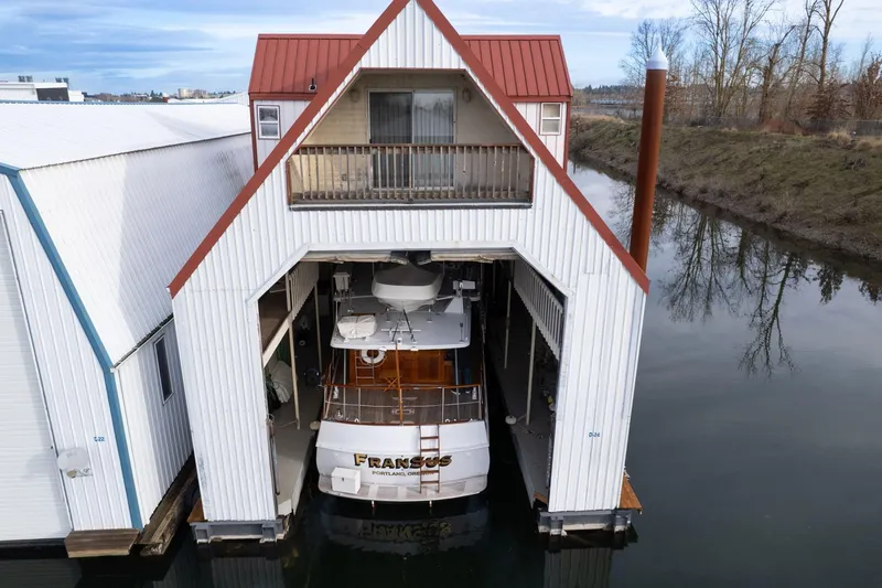 Slide: The Image of 1965 De Vries Lentsch 64 Motoryacht docked in a covered boathouse. - 122