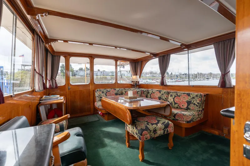 Slide: The Image of Interior of 1965 De Vries Lentsch 64 Motoryacht with floral seating and wooden accents. - 16