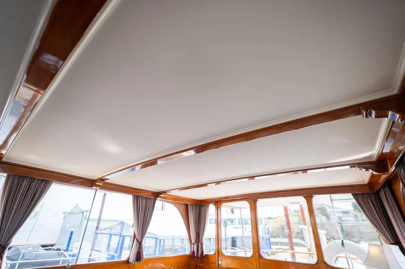 Slide: The Image of Interior view of 1965 De Vries Lentsch 64 Motoryacht with elegant wood trim and large windows. - 21