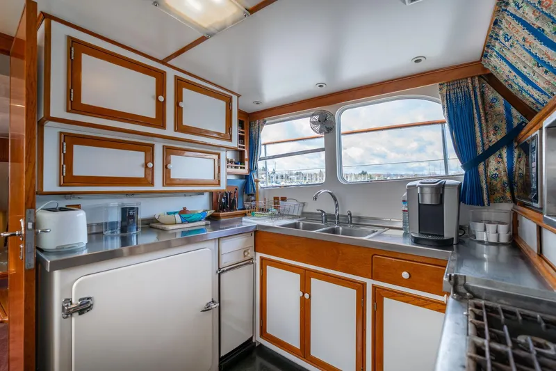 Slide: The Image of Galley kitchen in 1965 De Vries Lentsch 64 Motoryacht with stainless steel counters and wooden cabinets. - 34