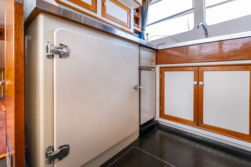 Slide: The Image of Vintage kitchen interior of 1965 De Vries Lentsch 64 Motoryacht with wooden cabinets. - 36