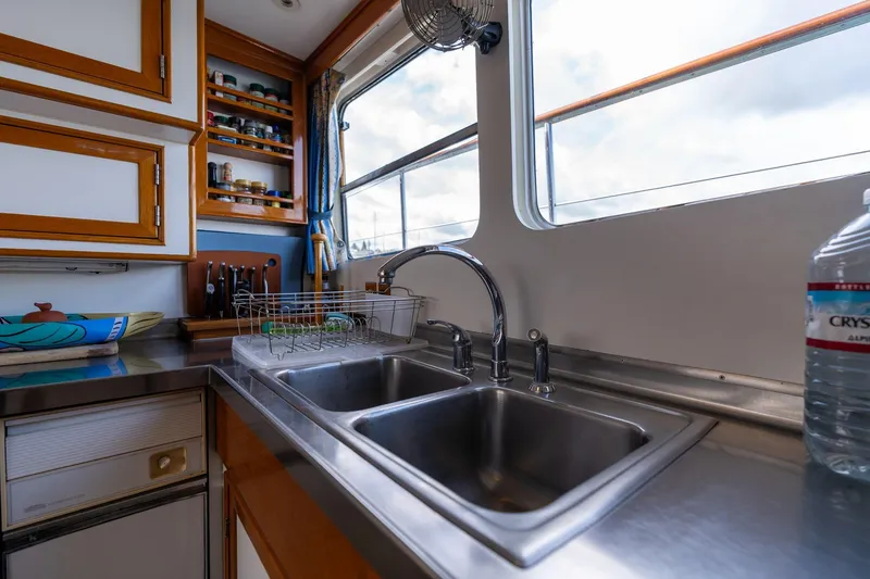 Slide: The Image of Kitchen area of 1965 De Vries Lentsch 64 Motoryacht with stainless steel sink and wooden cabinets. - 38