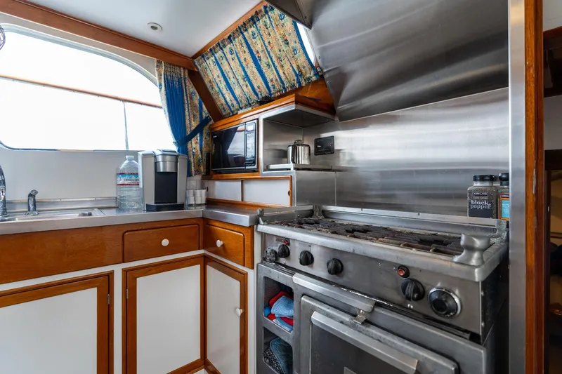Slide: The Image of Vintage 1965 De Vries Lentsch 64 Motoryacht kitchen with stove and wooden cabinetry. - 39
