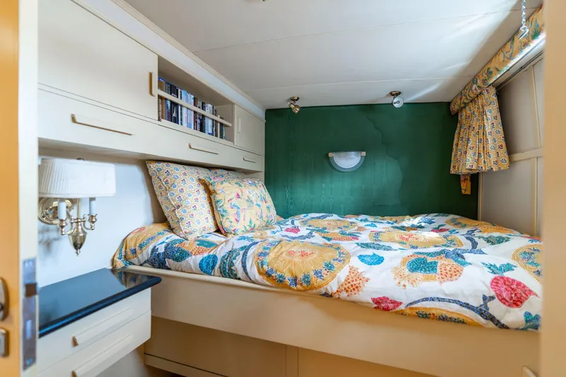 Slide: The Image of Cozy bedroom in 1965 De Vries Lentsch 64 Motoryacht with colorful bedding and built-in storage. - 47