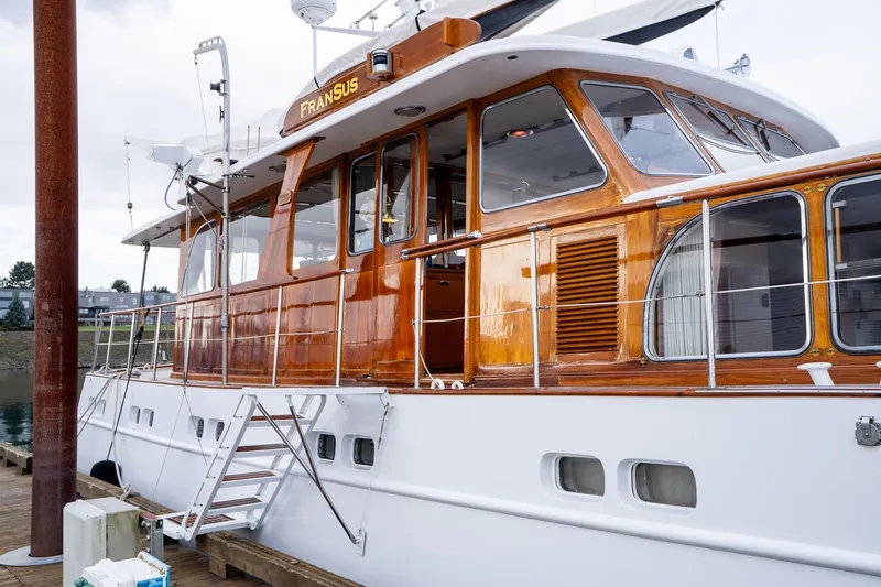 Slide: The Image of Classic 1965 De Vries Lentsch 64 Motoryacht with polished wood finish docked at marina. - 5