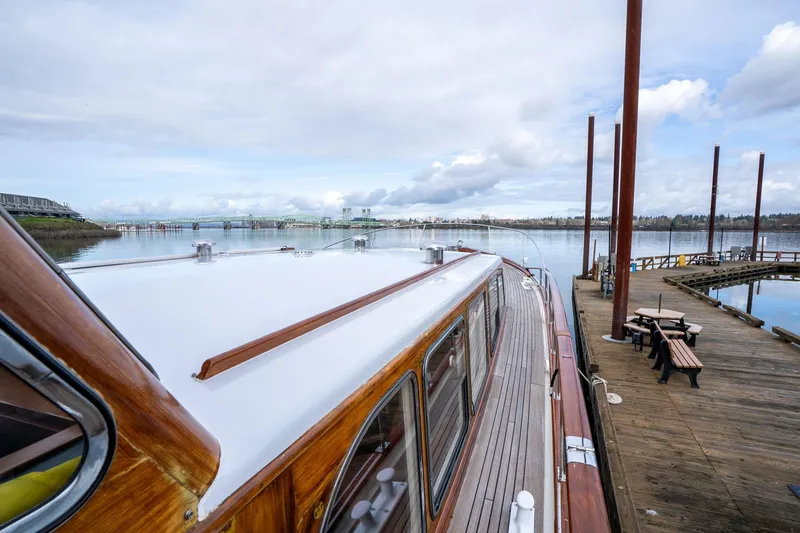 Slide: The Image of Classic 1965 De Vries Lentsch 64 Motoryacht docked by a serene waterfront. - 59
