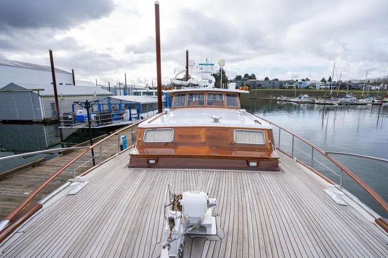 Slide: The Image of 1965 De Vries Lentsch 64 Motoryacht docked, showcasing elegant wooden deck and classic design. - 63