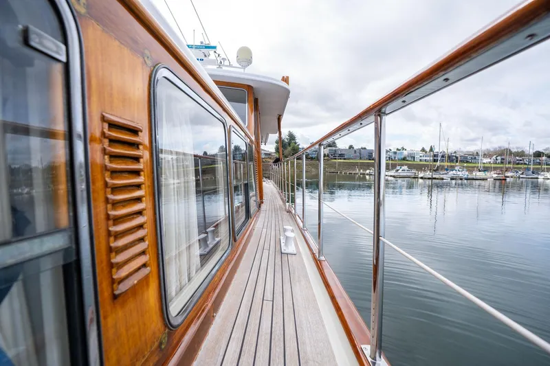 Slide: The Image of Side view of a 1965 De Vries Lentsch 64 Motoryacht docked by a calm marina. - 66