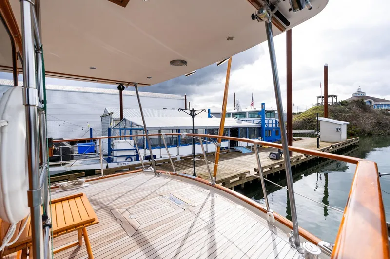 Slide: The Image of De Vries Lentsch 64 Motoryacht 1965 docked at a marina with wooden deck. - 68