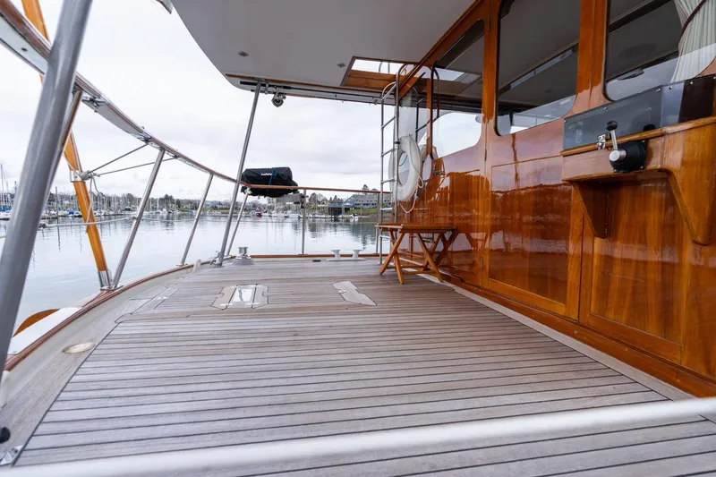 Slide: The Image of Elegant 1965 De Vries Lentsch 64 Motoryacht with polished wood deck and marina view. - 69