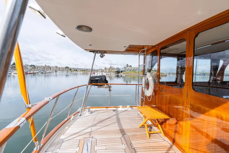 Slide: The Image of Elegant 1965 De Vries Lentsch 64 Motoryacht with polished wood deck and serene marina view. - 70