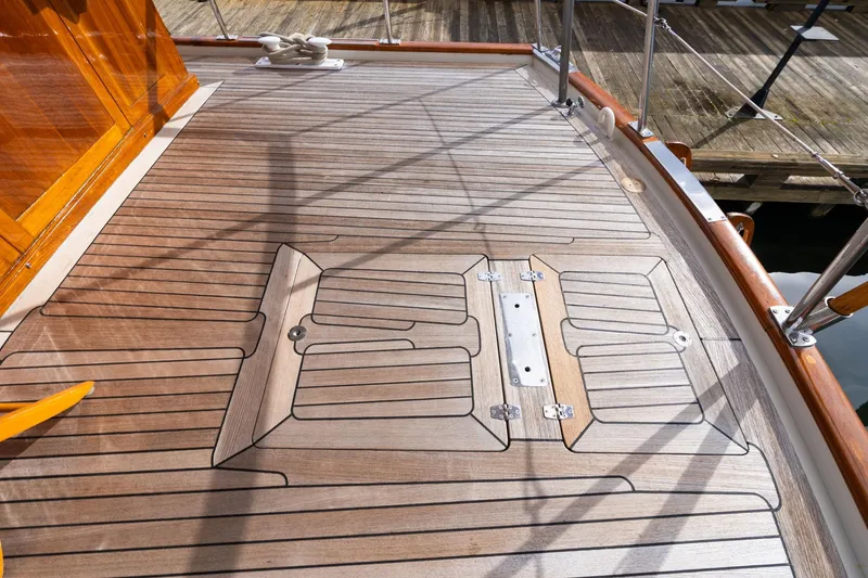 Slide: The Image of Teak deck of 1965 De Vries Lentsch 64 Motoryacht, featuring elegant woodwork and metal fittings. - 73