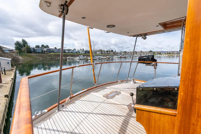 Slide: The Image of 1965 De Vries Lentsch 64 Motoryacht deck overlooking serene marina and waterfront homes. - 74