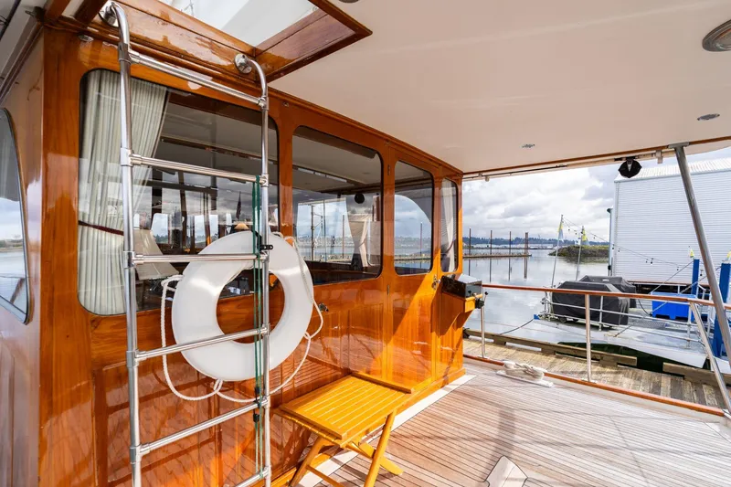 Slide: The Image of 1965 De Vries Lentsch 64 Motoryacht deck with wooden finish and life preserver. - 75