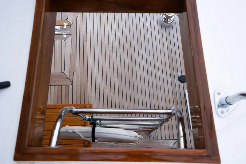 Slide: The Image of View from hatch of 1965 De Vries Lentsch 64 Motoryacht, showcasing wooden deck and ladder. - 76